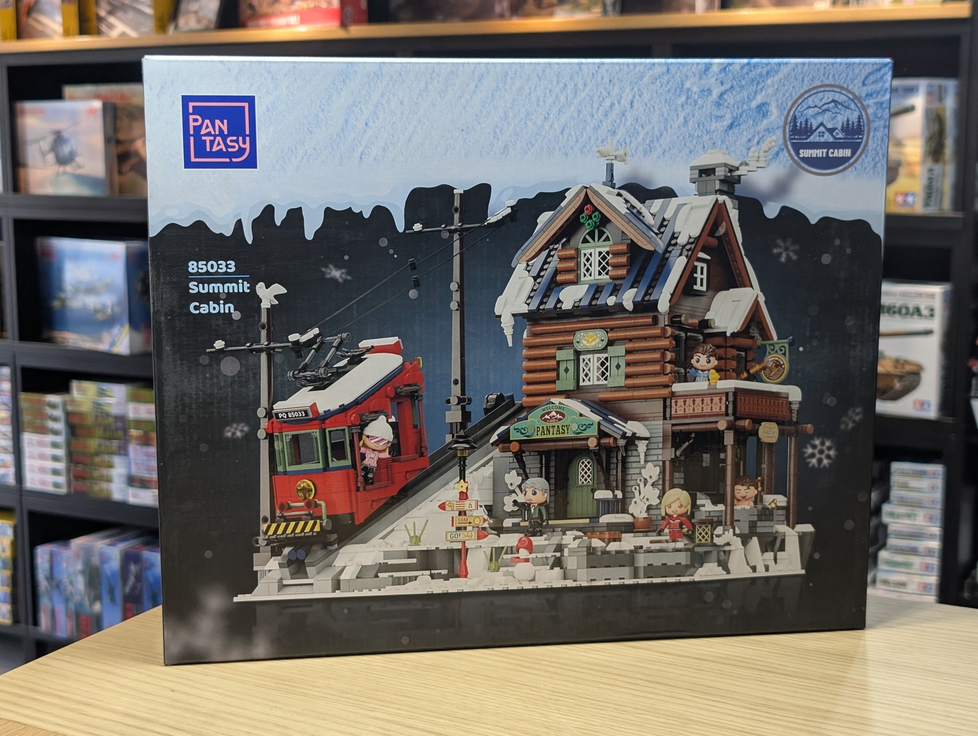 Boxed set of a model cabin with a red vehicle on a snowy landscape, featuring Pantasy branding.